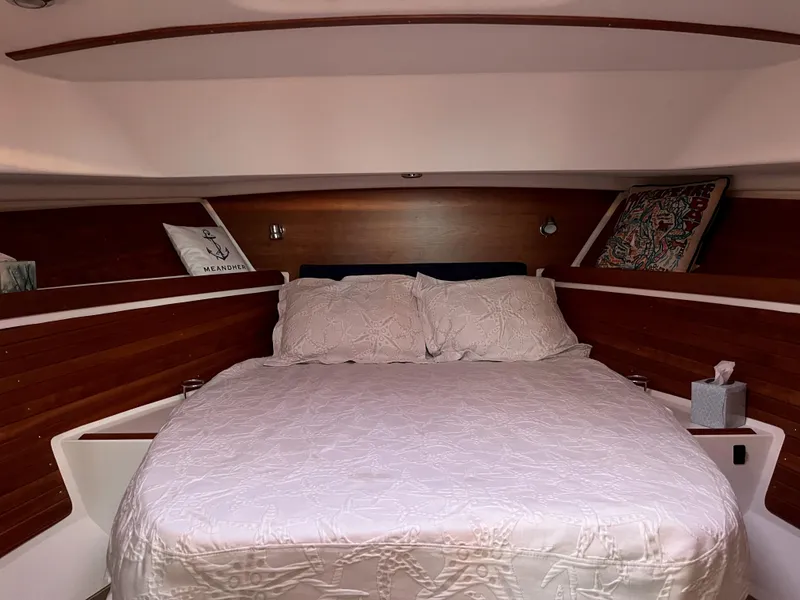 Slide: The Image of Cozy cabin interior of 2013 Back Cove 34 with a neatly made bed. - 13