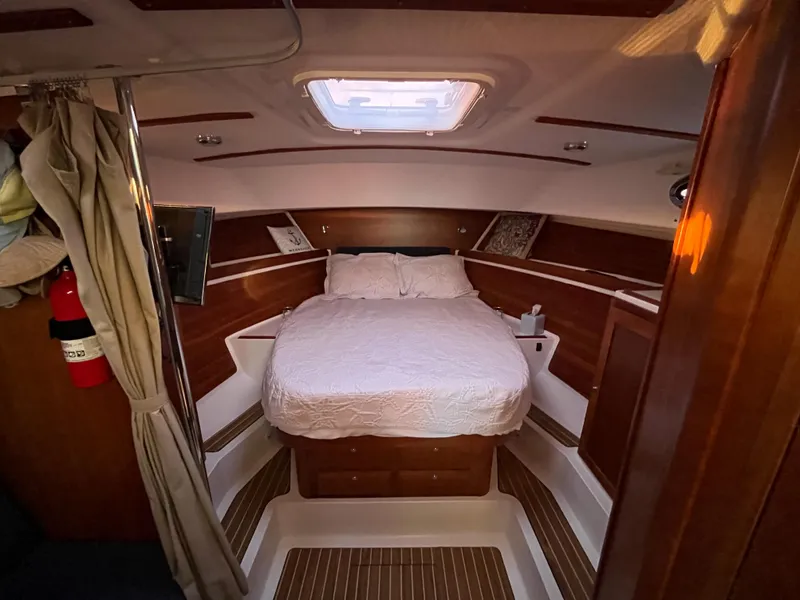 Slide: The Image of Cozy cabin interior of 2013 Back Cove 34 boat with bed and wood paneling. - 14