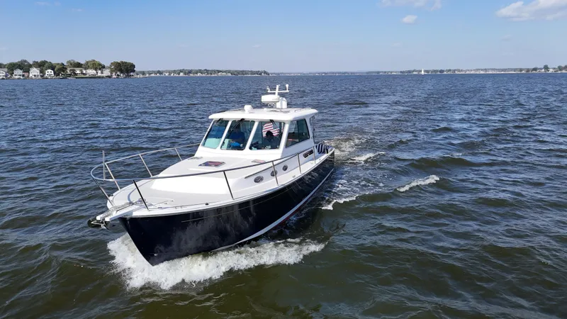 Slide: The Image of 2013 Back Cove 34 cruising on open water under a clear sky. - 2