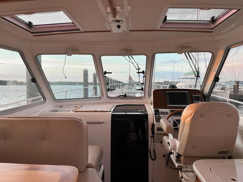Slide: The Image of Interior view of 2013 Back Cove 34 boat, featuring helm and seating area. - 30
