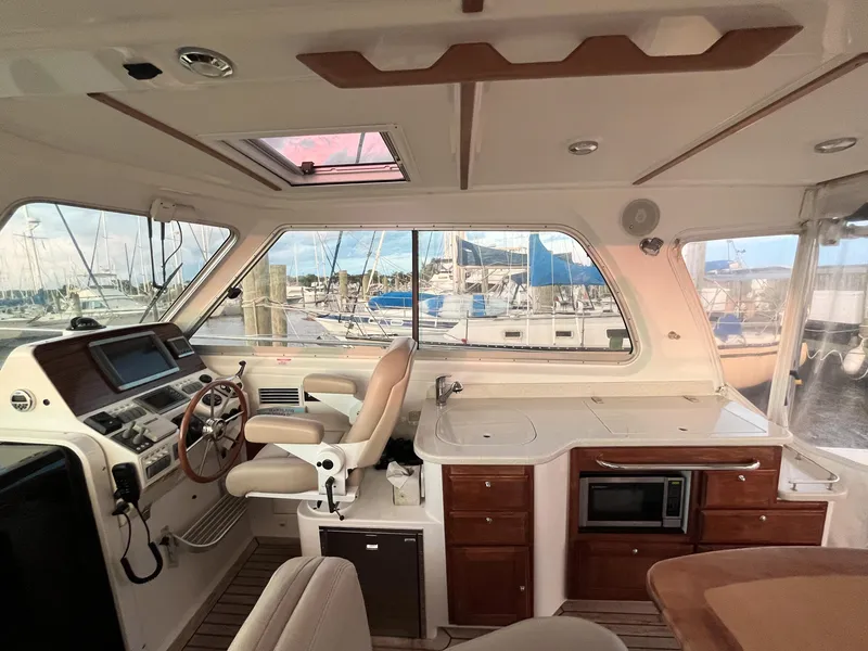 Slide: The Image of Interior of 2013 Back Cove 34 yacht with helm, seating, and kitchenette. - 32