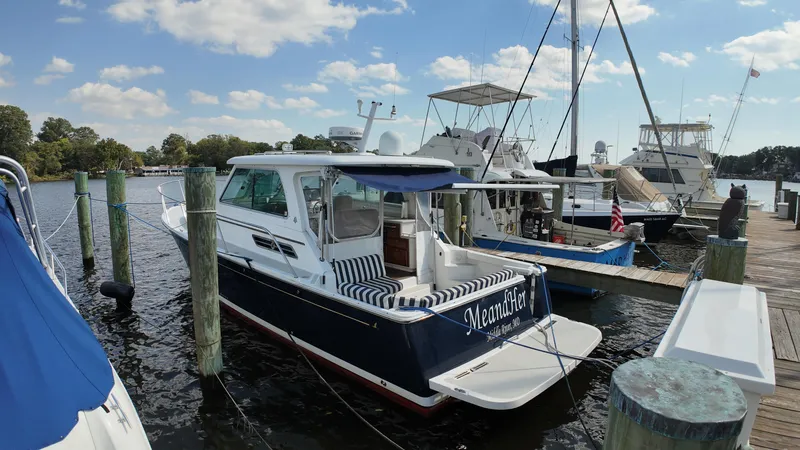 Slide: The Image of 2013 Back Cove 34 boat docked at marina under blue sky. - 41
