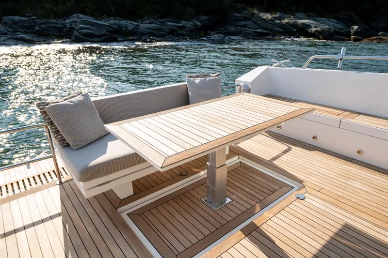 Slide: The Image of Luxurious 2017 Delta Powerboats 54 IPS yacht deck with elegant seating and table. - 18