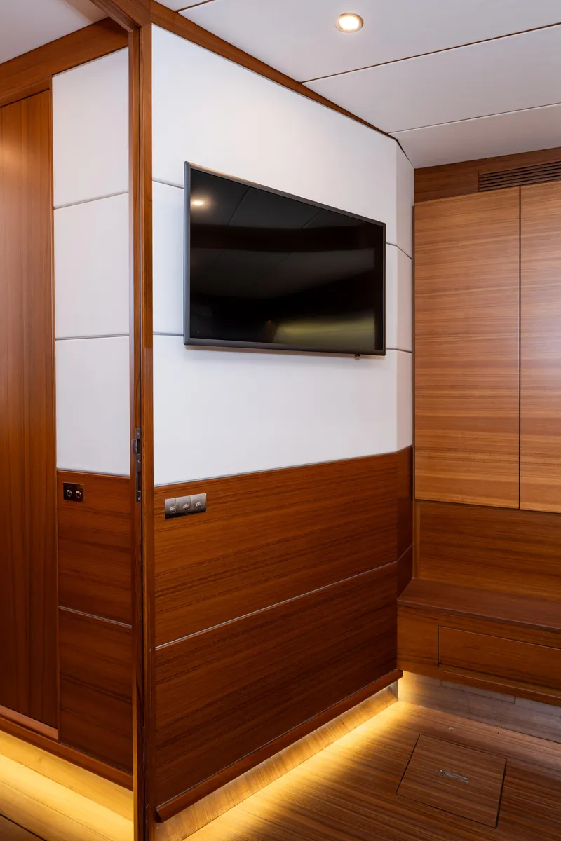 Slide: The Image of Interior of 2017 Delta Powerboats 54 IPS with modern wood paneling and wall-mounted TV. - 32