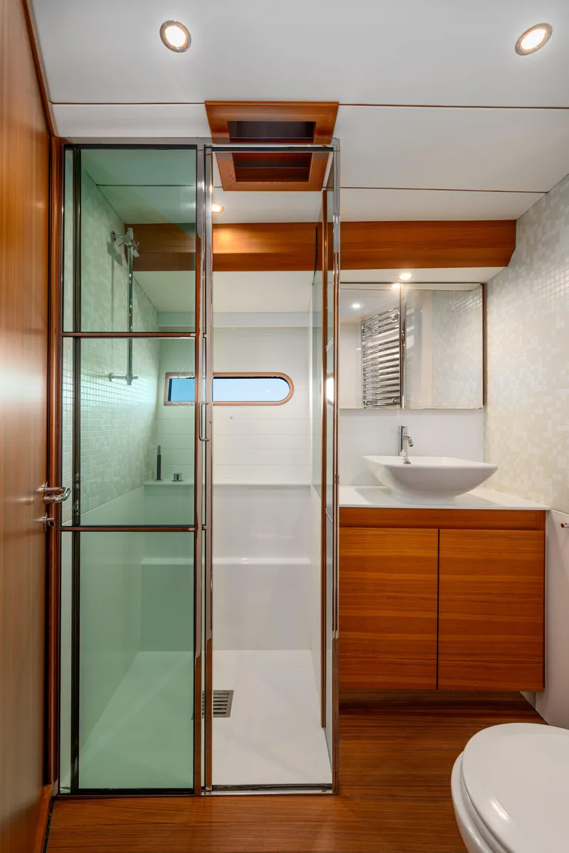 Slide: The Image of Luxurious bathroom in 2017 Delta Powerboats 54 IPS, featuring modern wood and glass design. - 36