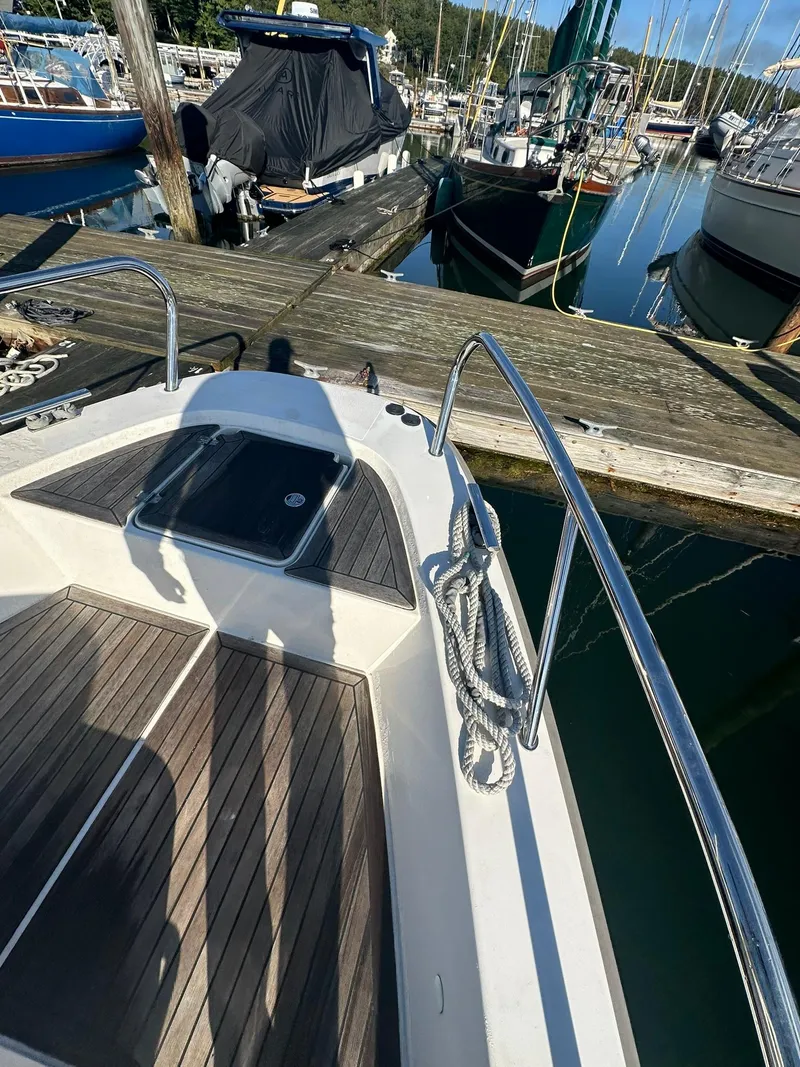 Slide: The Image of Nimbus C9 2021 boat docked at marina with wooden deck and railing. - 11