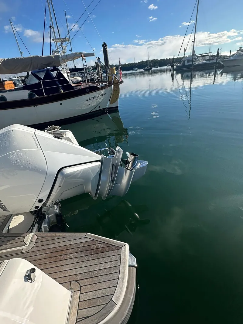 Slide: The Image of Nimbus C9 2021 boat docked in a serene marina with clear skies. - 12