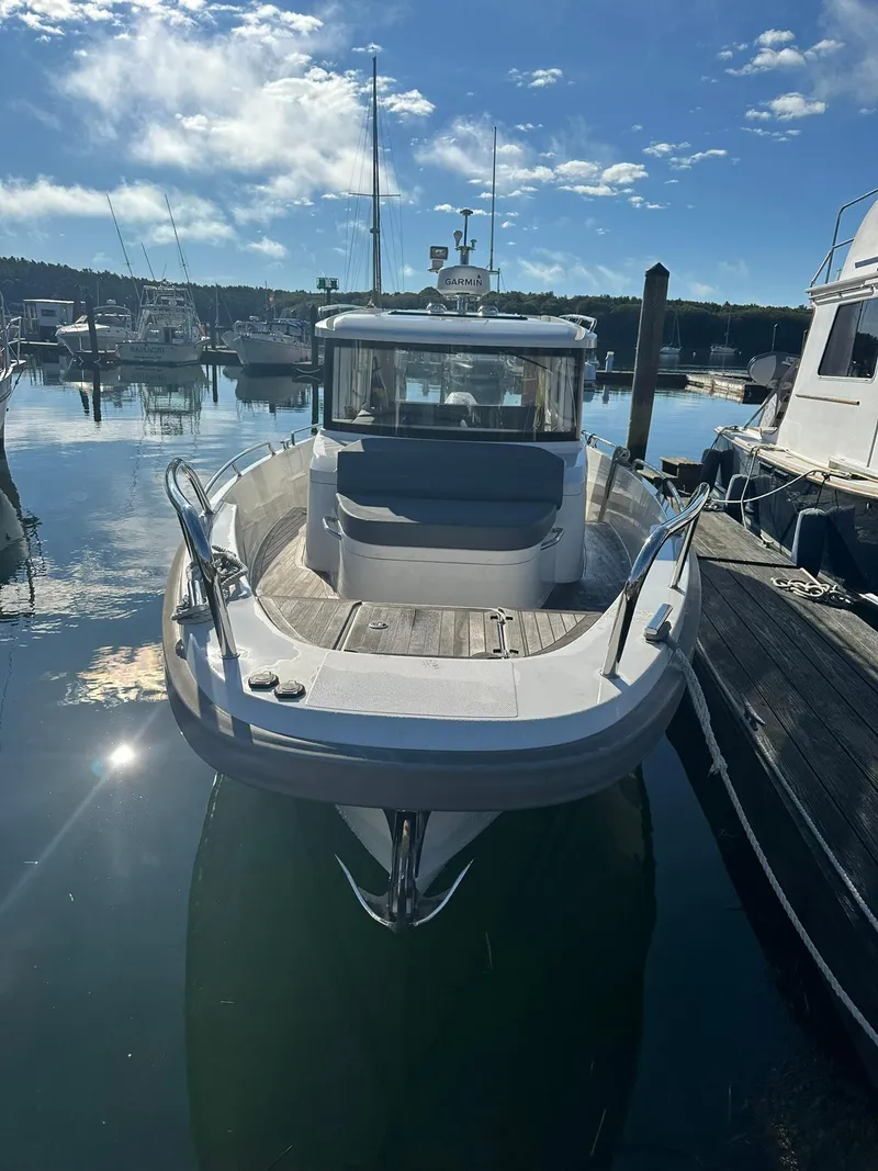 Slide: The Image of Nimbus C9 2021 boat docked in a marina under a clear blue sky. - 2