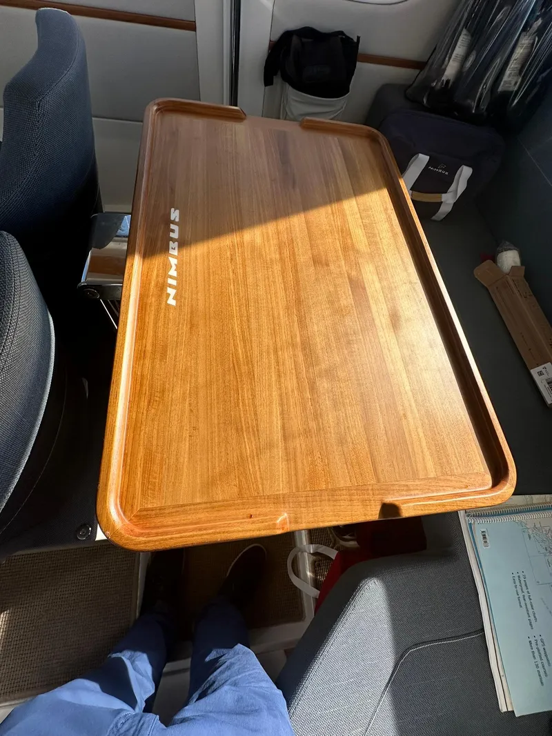 Slide: The Image of Wooden table in a Nimbus C9 boat interior, 2021 model, with sunlight and seating. - 20