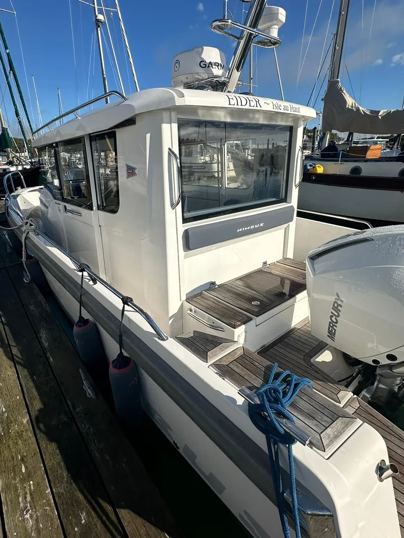 Slide: The Image of Nimbus C9 2021 boat docked, featuring Mercury engine and Garmin equipment. - 3