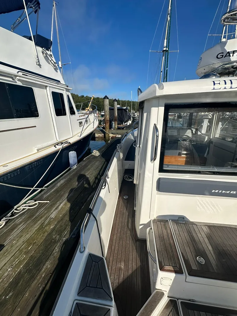 Slide: The Image of Nimbus C9 2021 boat docked at marina under clear blue sky. - 7