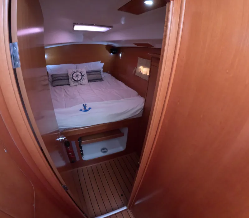 Slide: The Image of Cozy cabin interior of 2004 Lagoon 380 catamaran with nautical-themed bedding. - 10