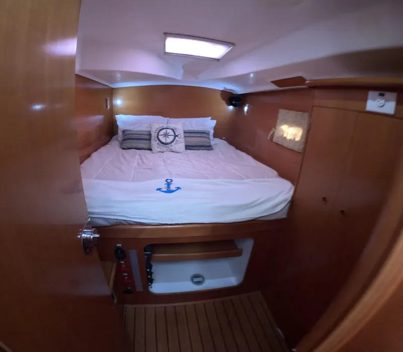 Slide: The Image of Cozy cabin interior of 2004 Lagoon 380 catamaran with nautical-themed bedding. - 11