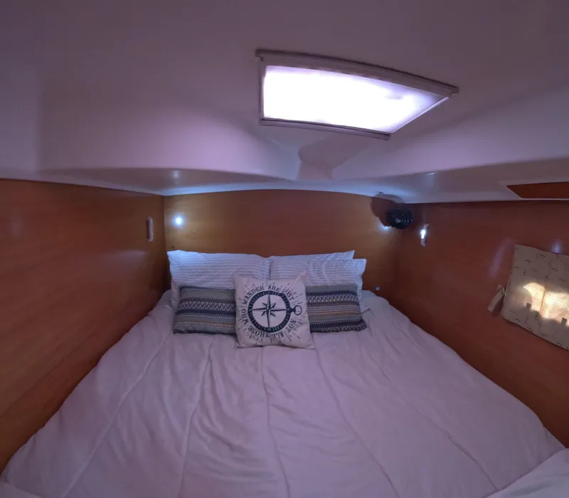 Slide: The Image of Cozy cabin interior of 2004 Lagoon 380 catamaran with comfortable bedding and soft lighting. - 12