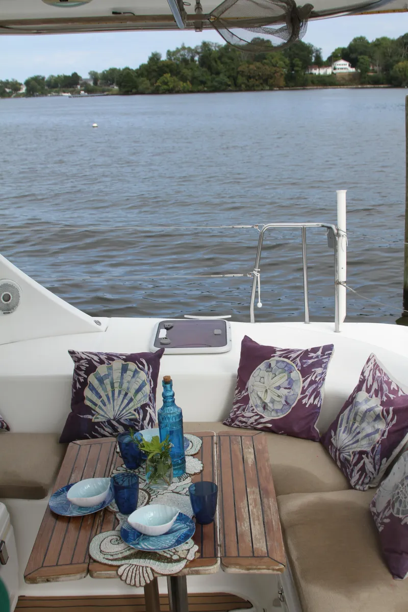 Slide: The Image of Cozy dining setup on 2004 Lagoon 380 catamaran with scenic water view. - 16