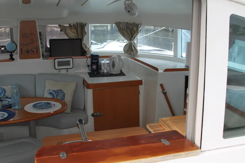 Slide: The Image of Interior of 2004 Lagoon LAGOON 380 catamaran with cozy dining area and kitchenette. - 18