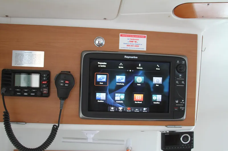 Slide: The Image of Control panel of 2004 Lagoon LAGOON 380 with Raymarine navigation system and communication devices. - 24