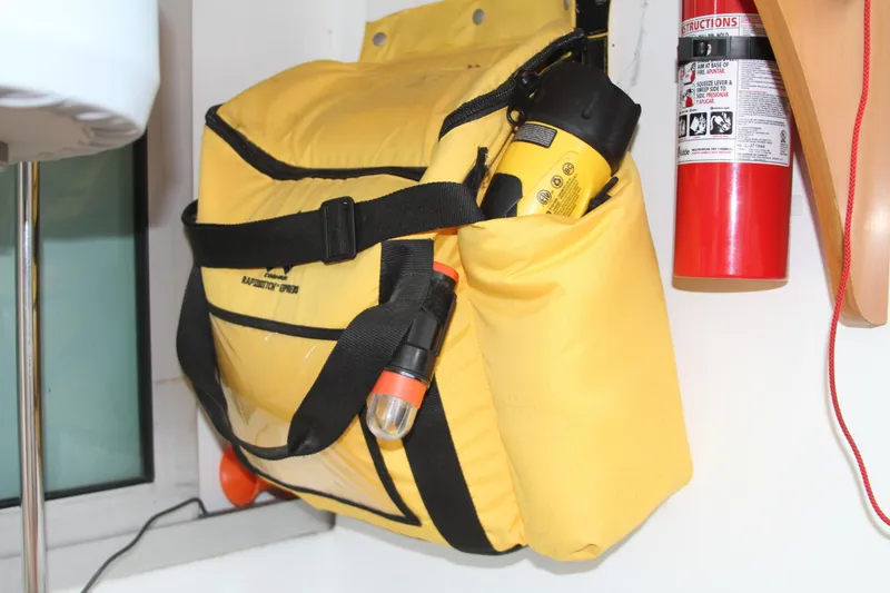 Slide: The Image of Yellow safety bag with flashlight and fire extinguisher on Lagoon 380, 2004 model. - 34