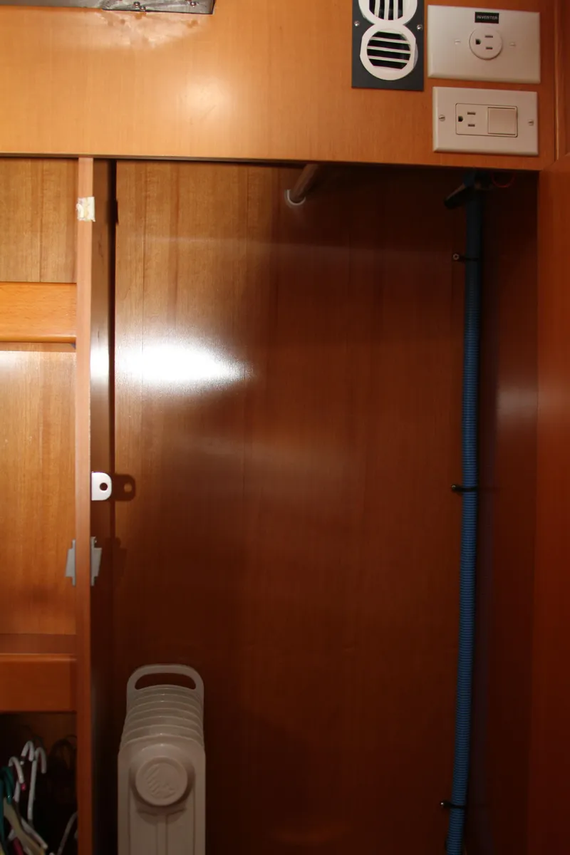 Slide: The Image of Interior of 2004 Lagoon LAGOON 380 yacht, featuring wooden cabinetry and electrical outlets. - 36