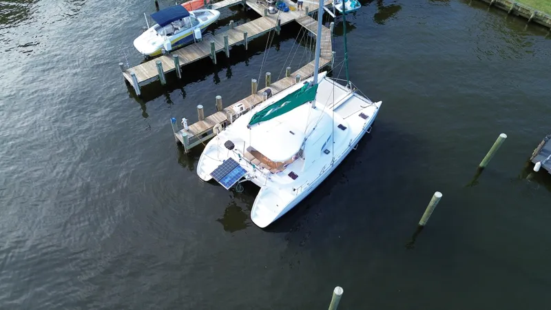 Slide: The Image of Aerial view of a 2004 Lagoon 380 catamaran docked at a marina. - 4