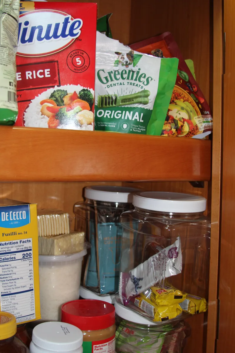 Slide: The Image of Pantry shelf with assorted food items, including rice, pasta, and pet treats. - 40