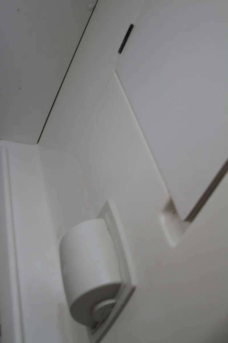 Slide: The Image of Interior detail of a 2004 Lagoon 380 yacht, featuring sleek white surfaces. - 48