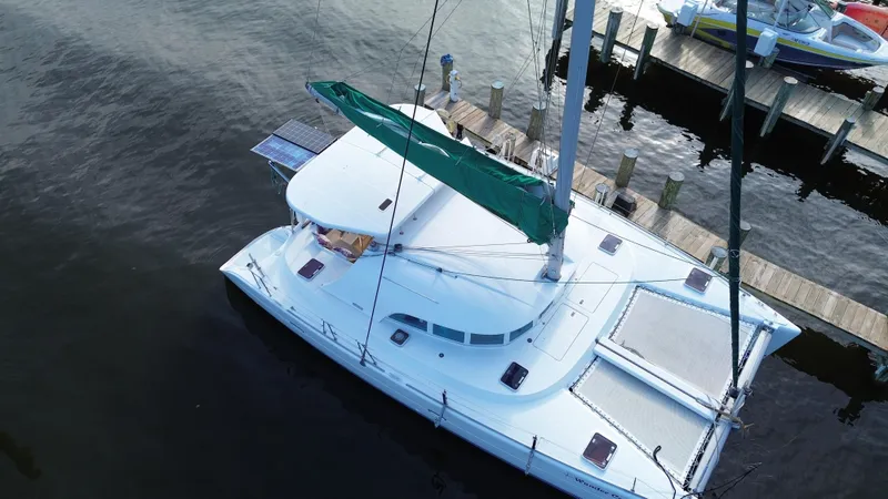 Slide: The Image of Aerial view of a 2004 Lagoon 380 catamaran docked at a marina. - 5