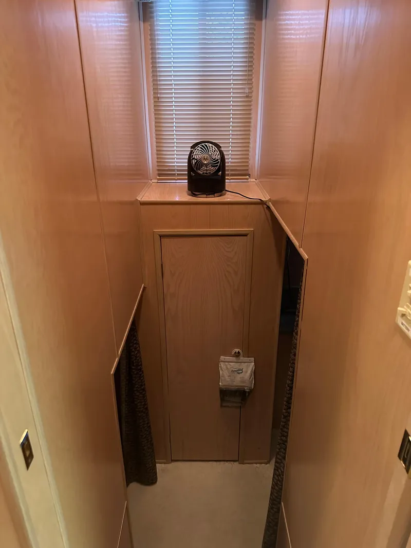 Slide: The Image of Narrow hallway in 1999 Lakeview houseboat with wooden walls and small window. - 11