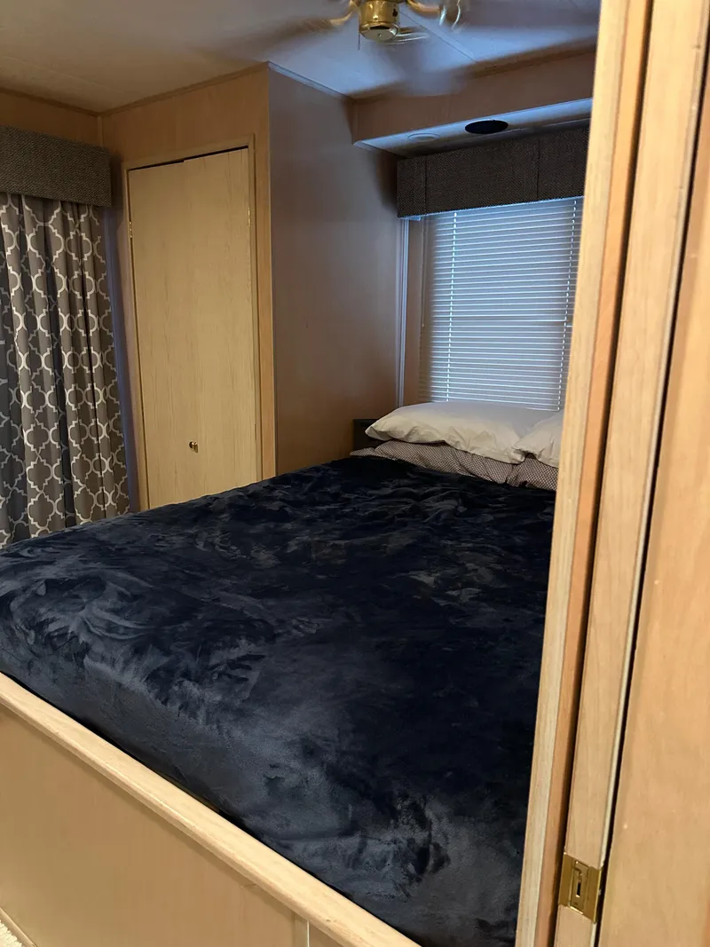 Slide: The Image of Cozy bedroom in 1999 Lakeview houseboat with dark bedding and window blinds. - 15