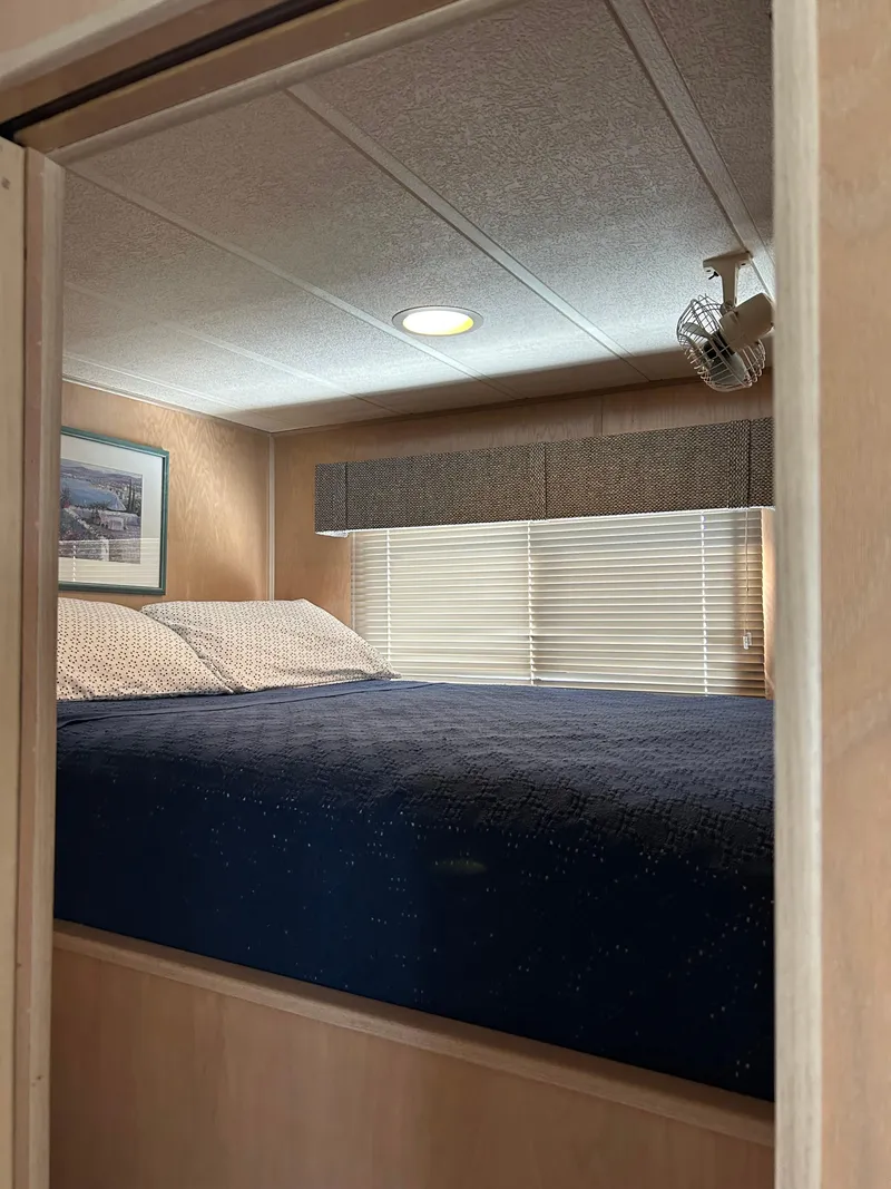 Slide: The Image of Cozy bedroom interior of 1999 Lakeview houseboat with bed, window, and wall art. - 8