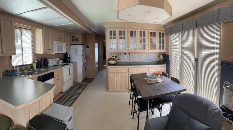 Slide: The Image of Spacious 1999 Lakeview houseboat kitchen and dining area with modern amenities and natural light. - 9