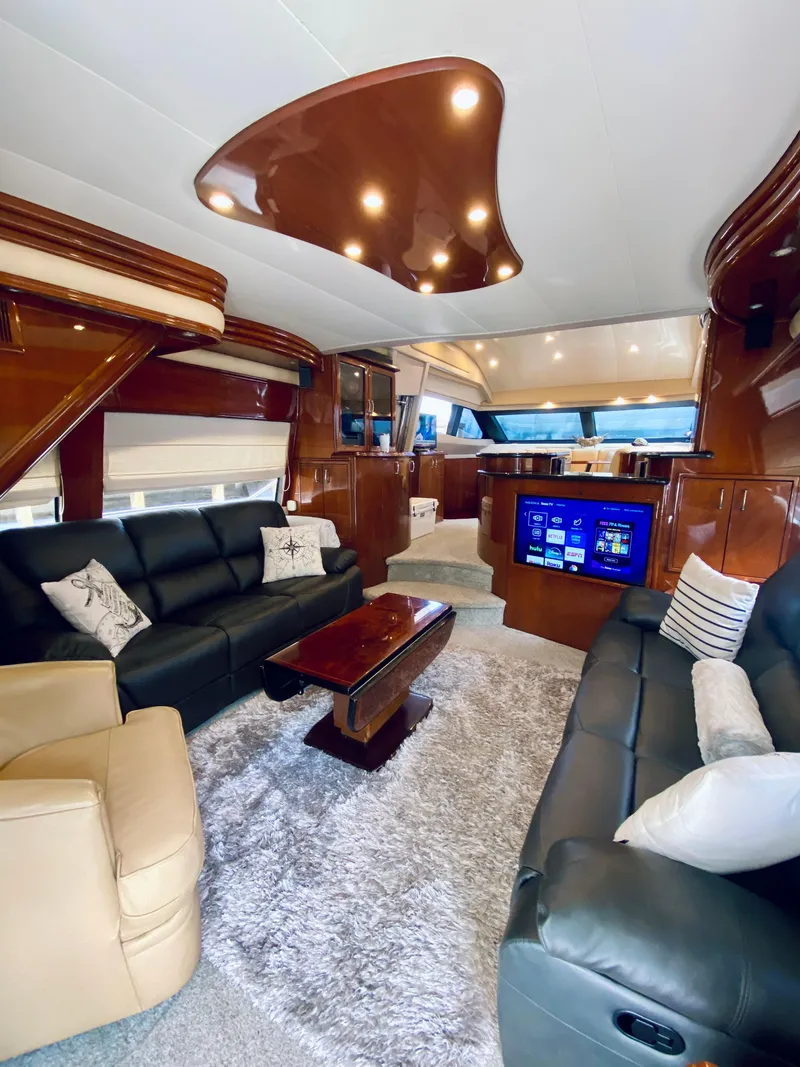 Slide: The Image of Luxurious 2006 Marquis 59 yacht interior with plush seating and modern entertainment system. - 38