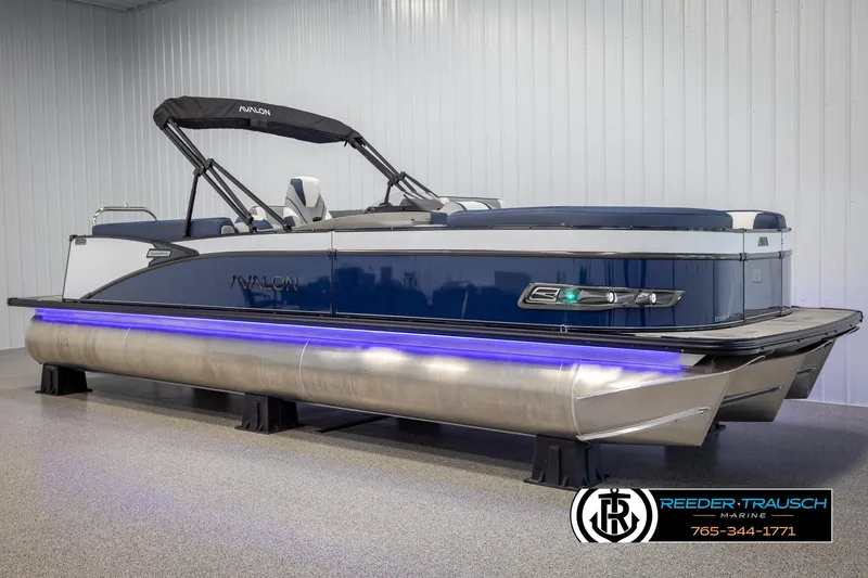 Slide: The Image of 2025 Avalon Catalina Entertainer pontoon boat with blue LED lights in showroom. - 2