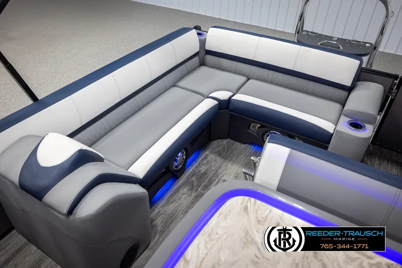 Slide: The Image of 2025 Avalon Catalina Entertainer boat interior with modern seating and blue LED lighting. - 22
