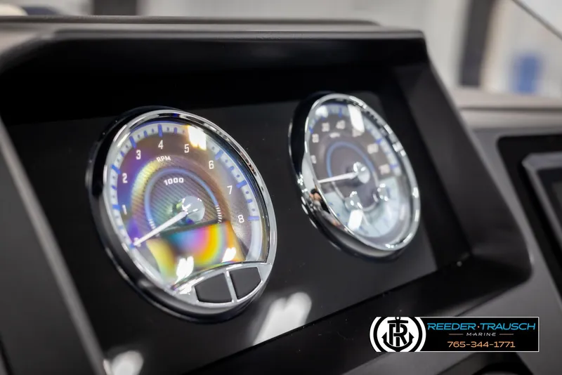 Slide: The Image of Close-up of 2025 Avalon Catalina Entertainer dashboard gauges, featuring RPM and speed indicators. - 31