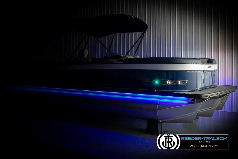 Slide: The Image of 2025 Avalon Catalina Entertainer pontoon boat with blue LED lights in a showroom. - 4