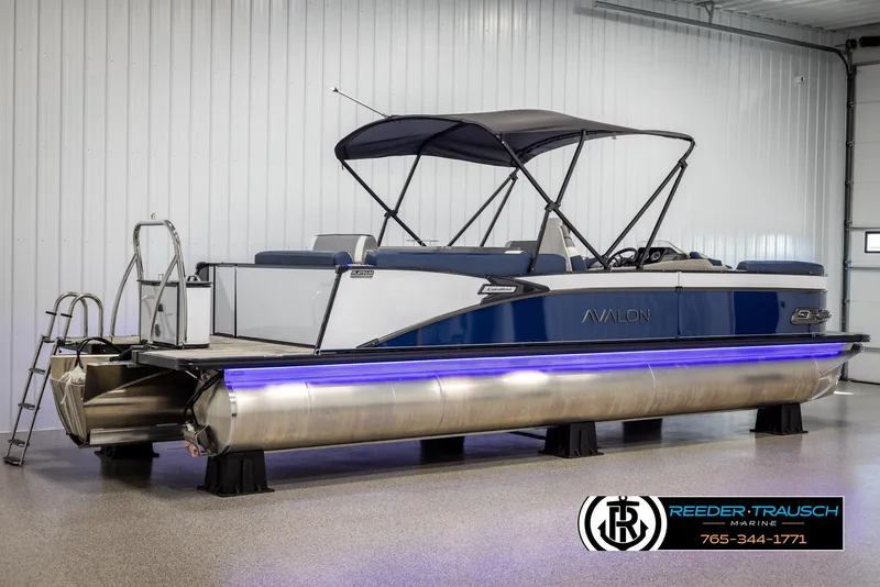 Slide: The Image of 2025 Avalon Catalina Entertainer pontoon boat with blue accents in a showroom. - 6