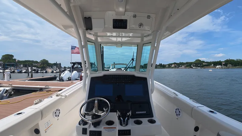 Slide: The Image of Interior view of a 2025 Sailfish 272 CC boat on water. - 15