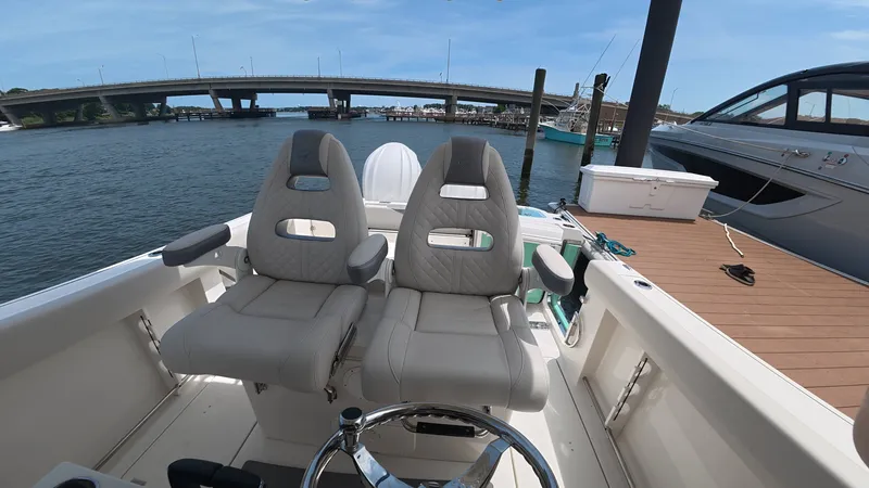 Slide: The Image of Sailfish 272 CC 2025 boat with two seats by the water. - 17