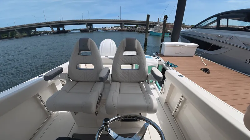 Slide: The Image of Sailfish 272 CC 2025 on water with bridge in background. - 18