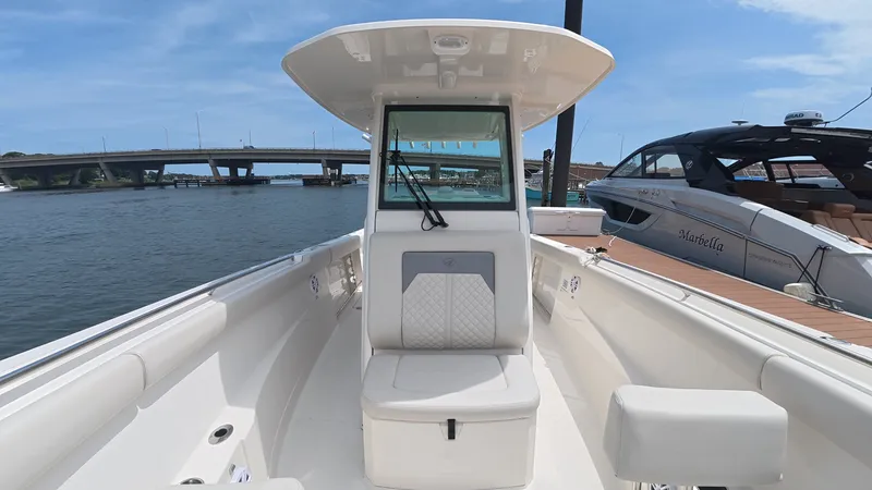 Slide: The Image of Sailfish 272 CC 2025 on water with bridge in background. - 23