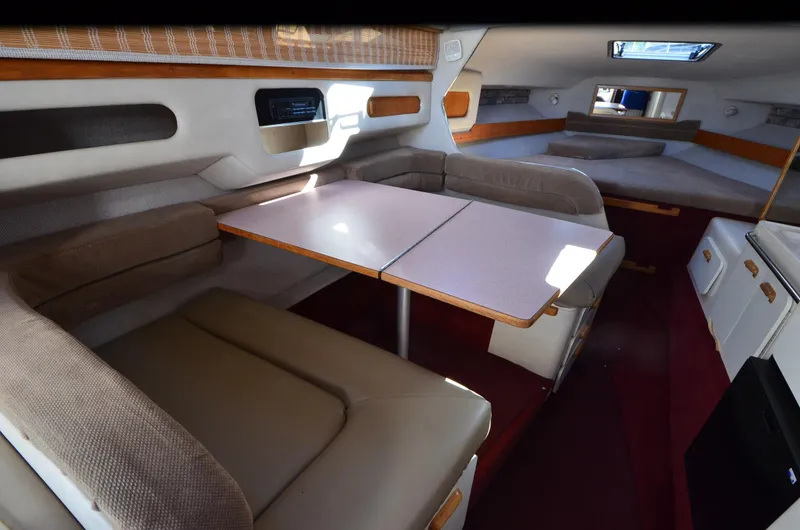 Slide: The Image of Interior of 1992 Sea Ray 290 Sundancer with dining area and seating. - 13