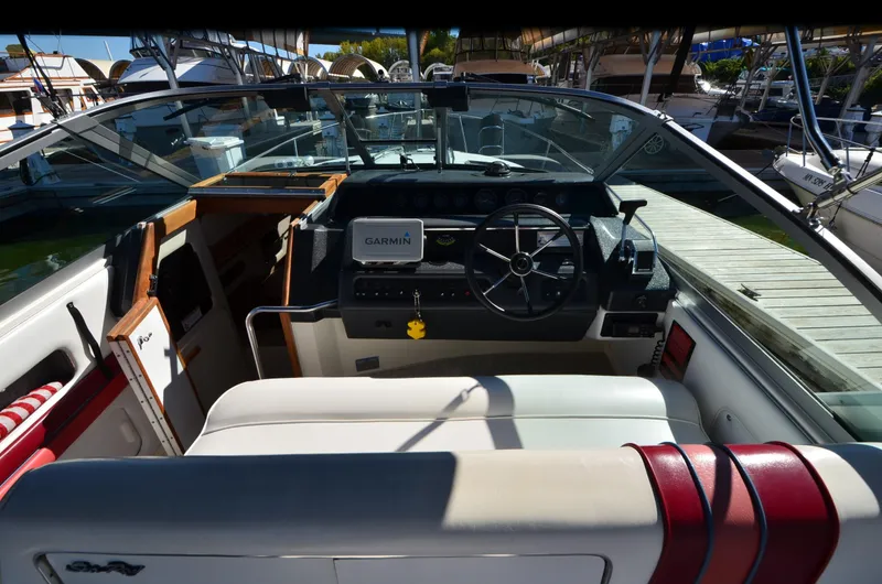 Slide: The Image of 1992 Sea Ray 290 Sundancer boat cockpit with Garmin navigation, docked at marina. - 16