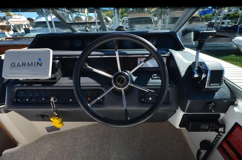Slide: The Image of 1992 Sea Ray 290 Sundancer helm with Garmin navigation system and steering wheel. - 17