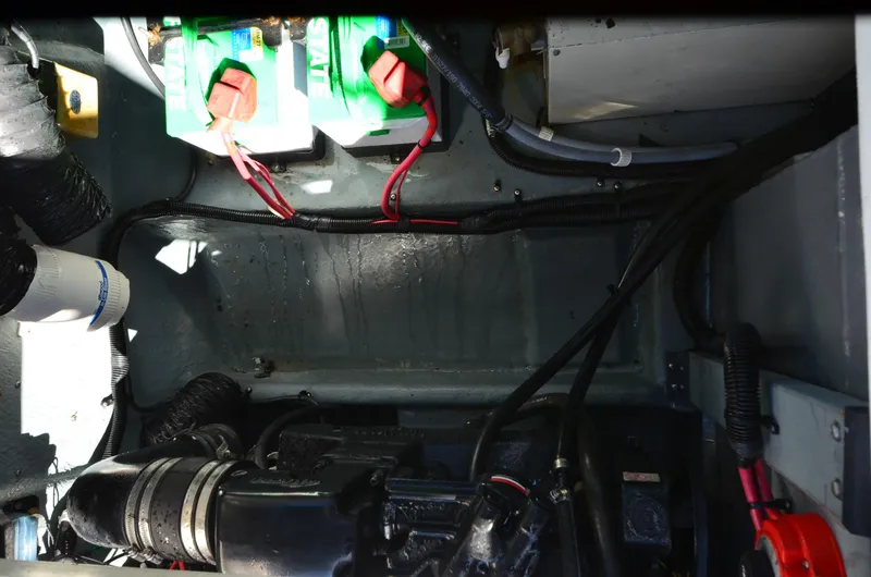 Slide: The Image of Engine compartment of a 1992 Sea Ray 290 Sundancer with visible batteries and wiring. - 23