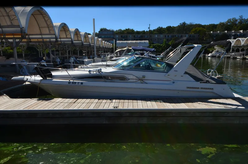 Slide: The Image of 1992 Sea Ray 290 Sundancer docked at marina, side view. - 26