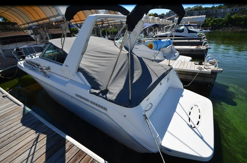 Slide: The Image of 1992 Sea Ray 290 Sundancer docked at marina, covered and ready for use. - 27