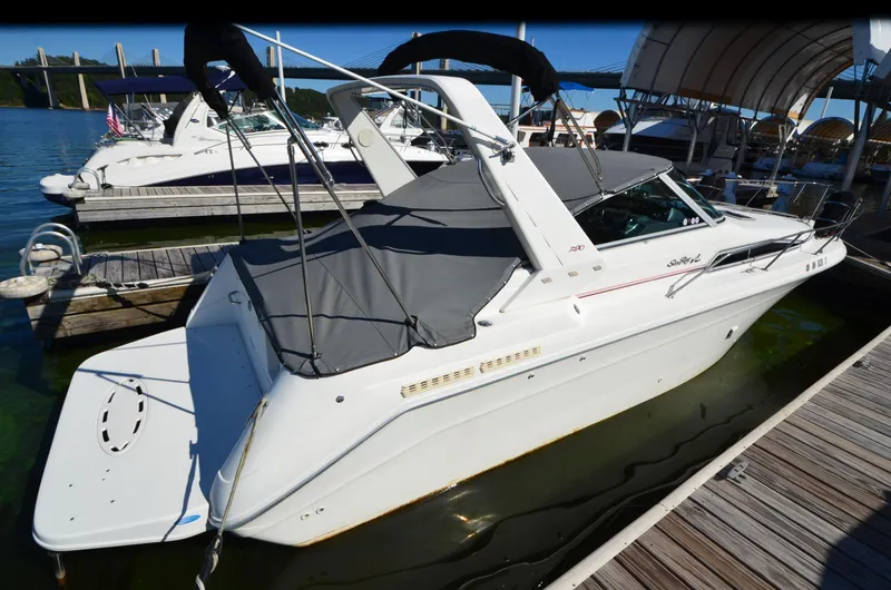 Slide: The Image of 1992 Sea Ray 290 Sundancer docked at marina, covered and ready for sailing. - 29