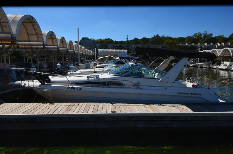 Slide: The Image of 1992 Sea Ray 290 Sundancer docked at marina under clear blue sky. - 3