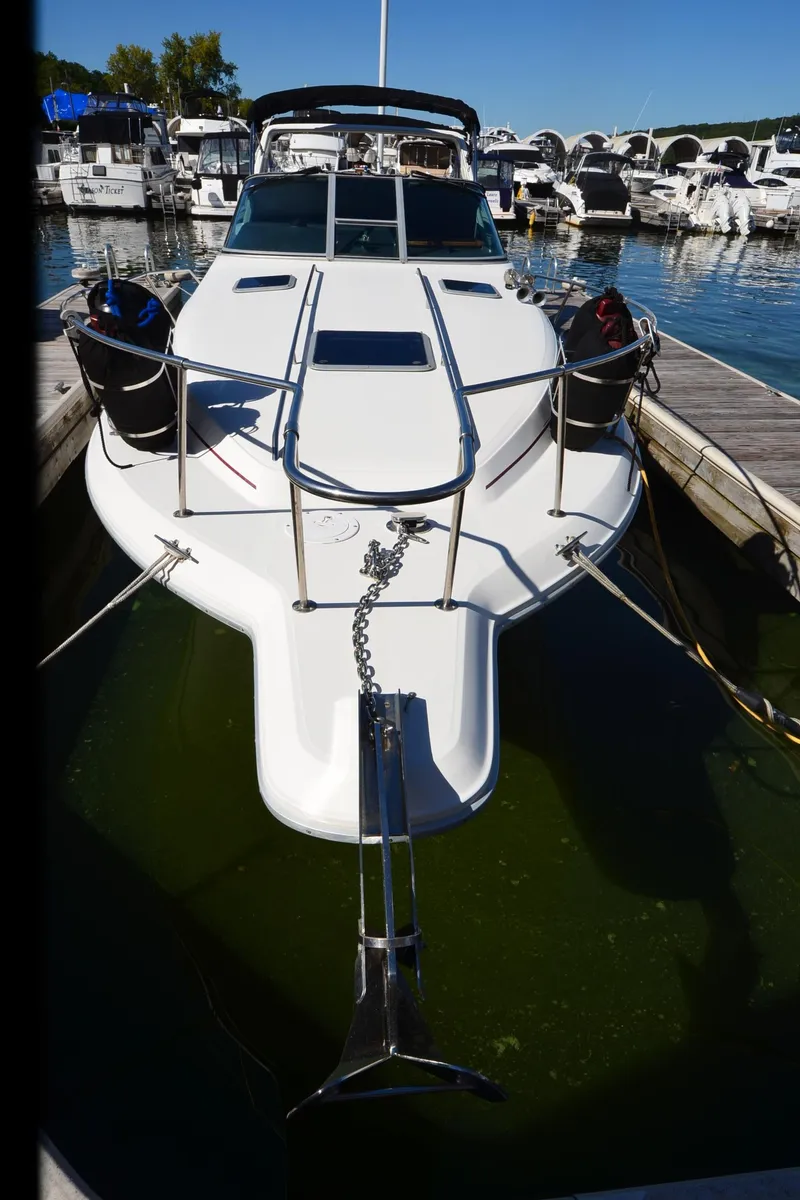Slide: The Image of 1992 Sea Ray 290 Sundancer docked at marina, front view. - 33